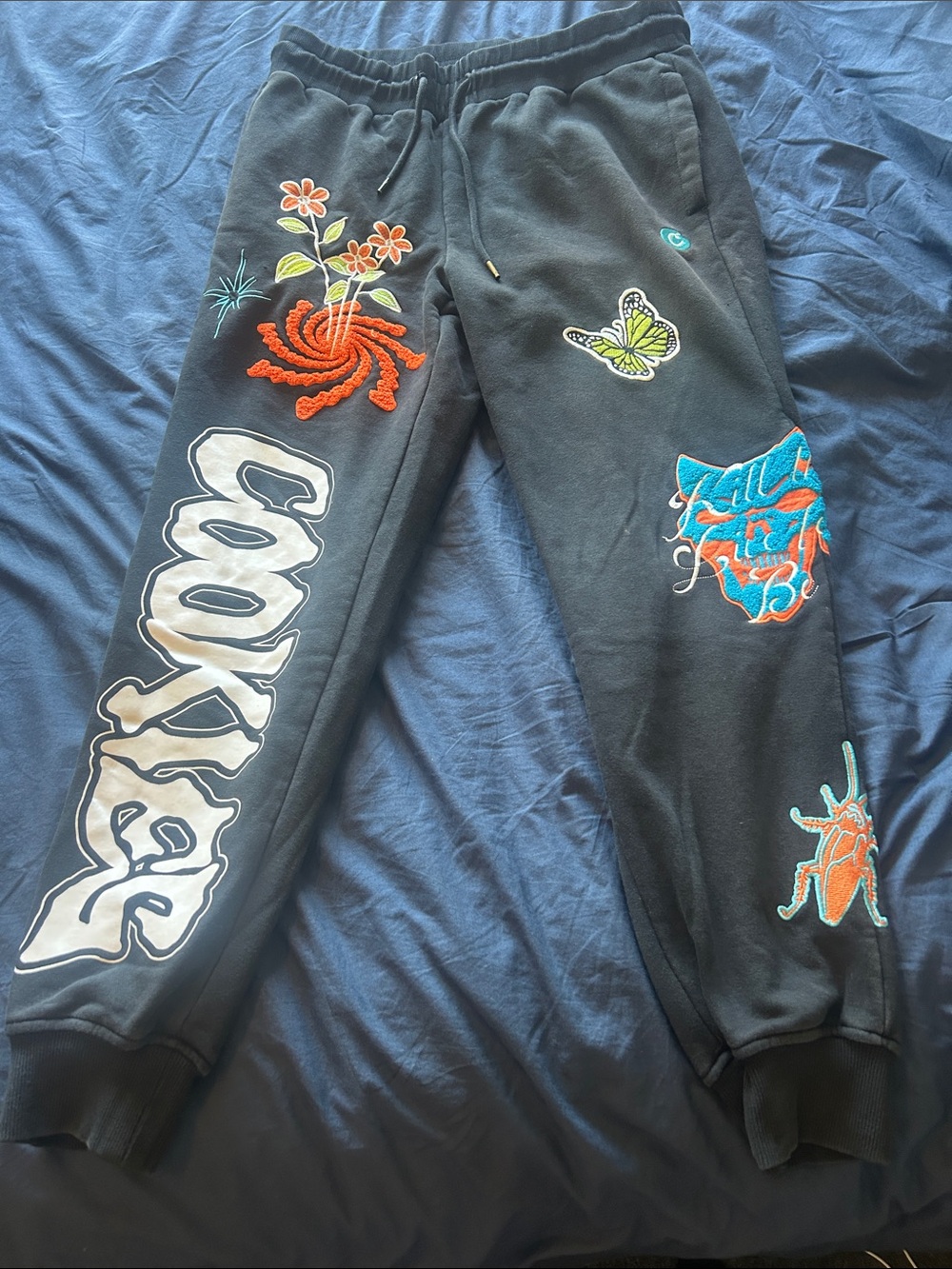 Men Black Graphic Jogger Sweatpants with Colorful Embroidery from Cookies